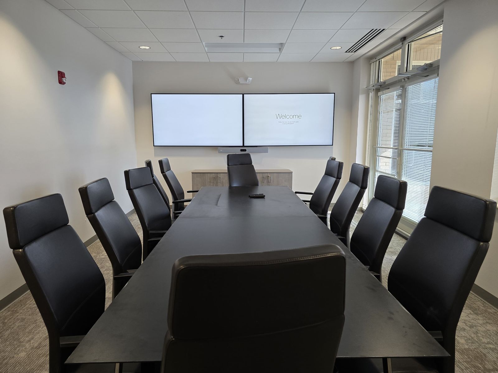 Conference room with dual wall displays installed by Vertex Prime Solutions