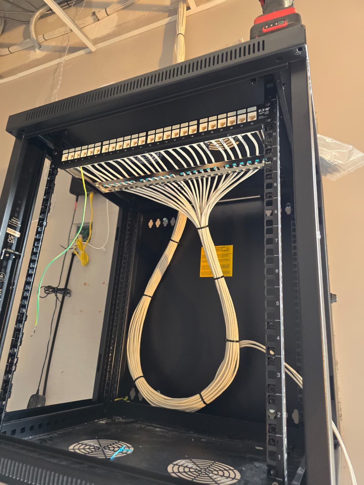 Wall-mount network rack with dressed patch panel cabling